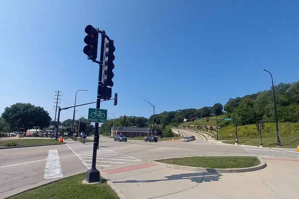 Quiet intersection of Prairie Trail and Main Street under a blue sky in Algonquin, Illinois