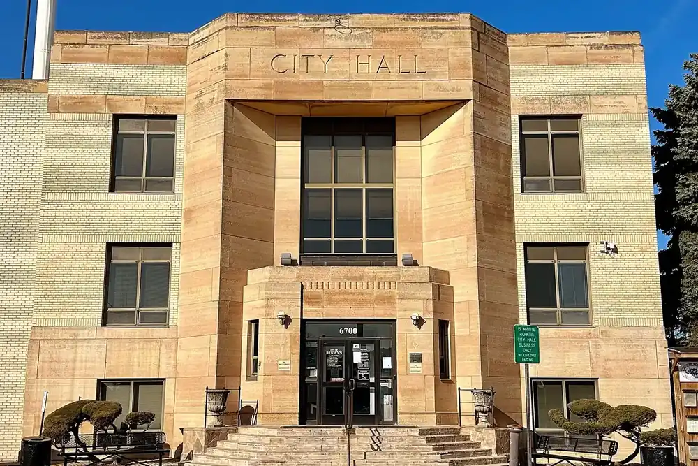 Art deco sandstone Berwyn City Hall entrance under a blue sky, Illinois