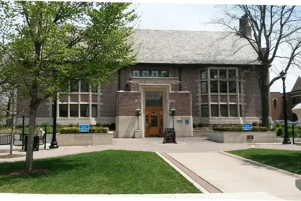 Brick River Forest Public Library entrance with a lawn and walkway, Illinois